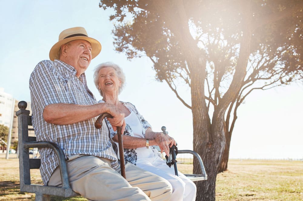 Female and Male Senior Memory Care Residents sitting outside